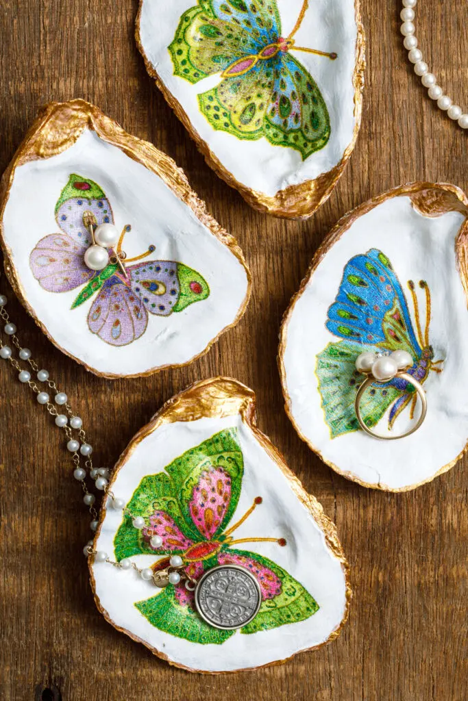 decoupage Oyster shells with jewelry on a wood table