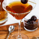 Manhattan cocktail garnished with a cherry