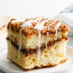 coffee cake with a drizzle topping on a plate