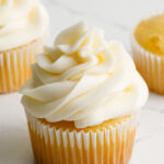 Cream cheese frosting on a yellow cupcake