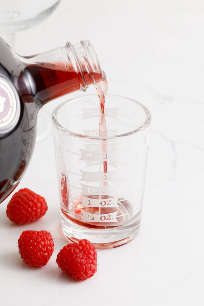 Measuring Chambord in a measuring cup
