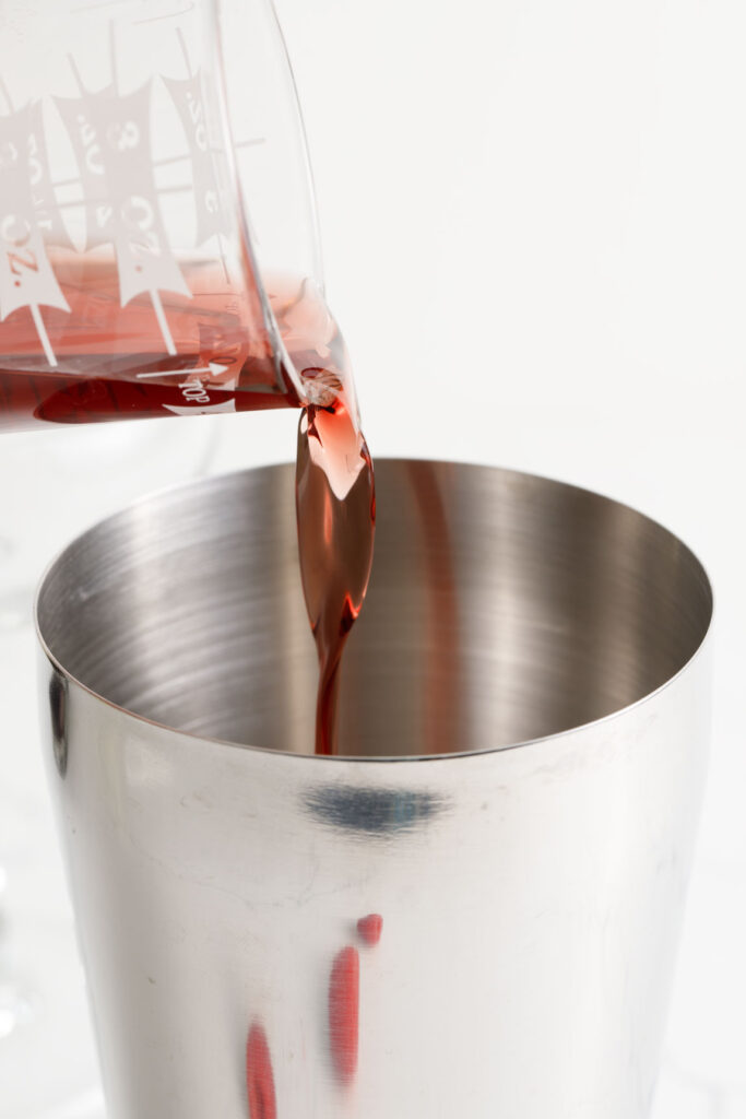 Pouring ingredients into a cocktail shaker
