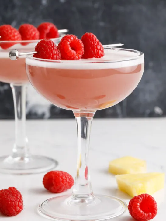 French martinis on a counter with a raspberry garnish