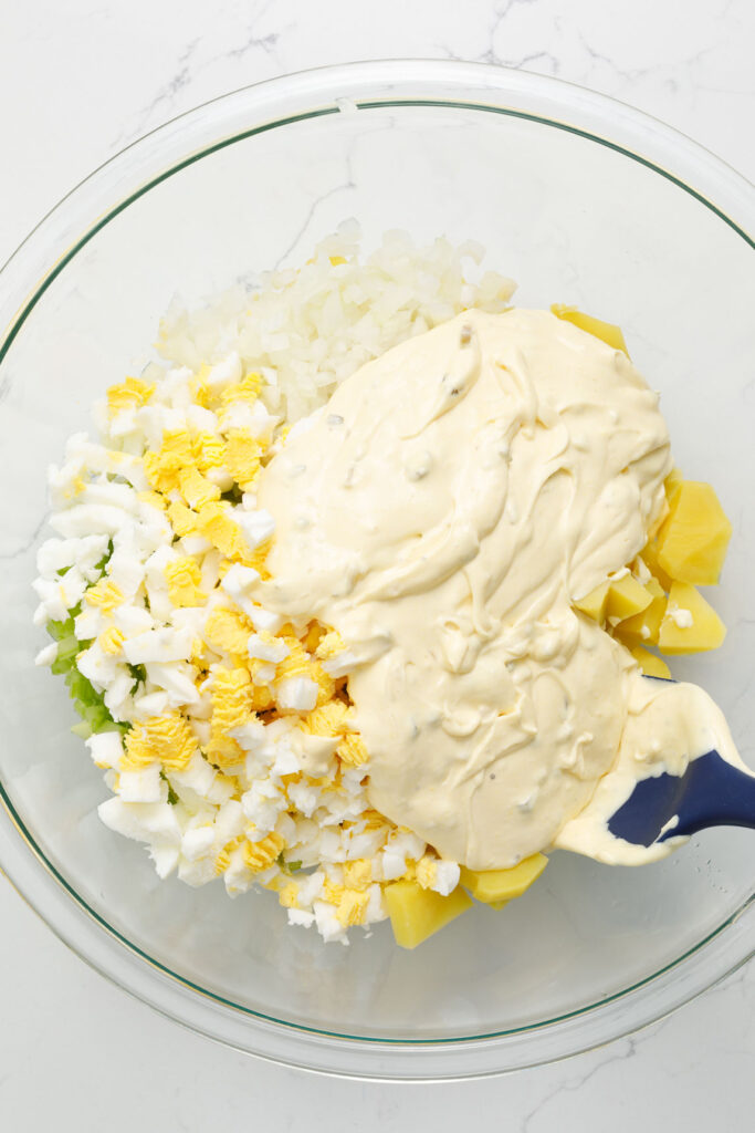 Combine potato salad ingredients with dressing 