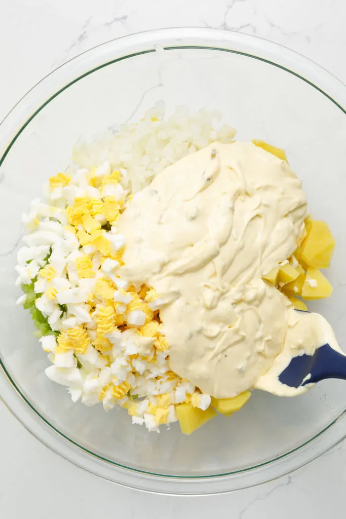 Combine potato salad ingredients with dressing