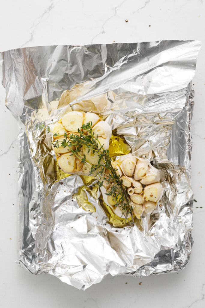 Garlic in foil with herbs and oil