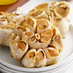 Three roasted blubs of garlic