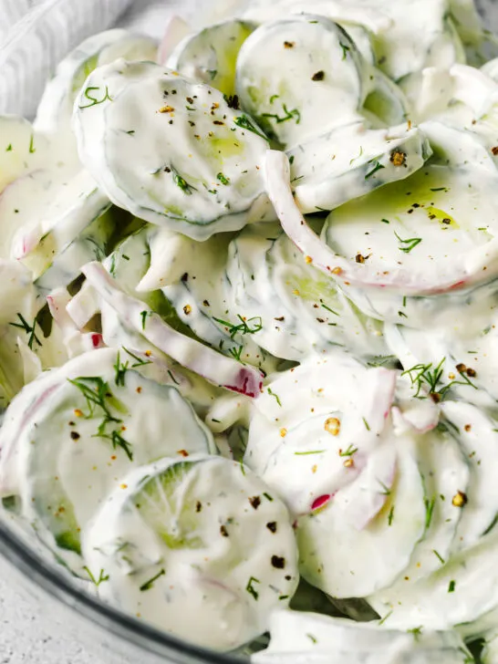 Salad garnished with fresh cracked pepper and fresh dill