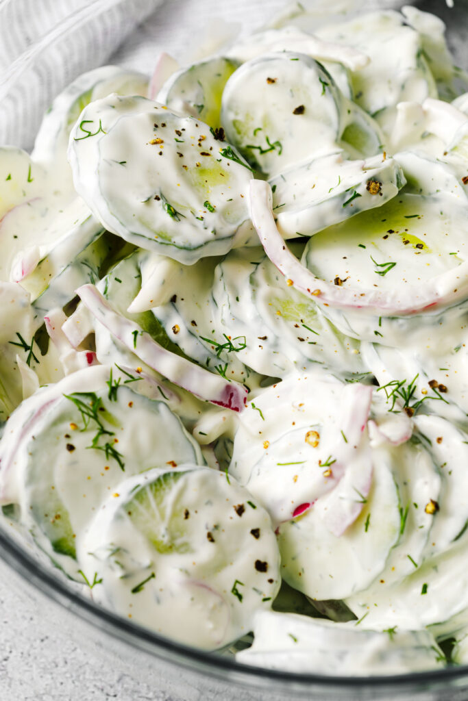 Salad garnished with fresh cracked pepper and fresh dill