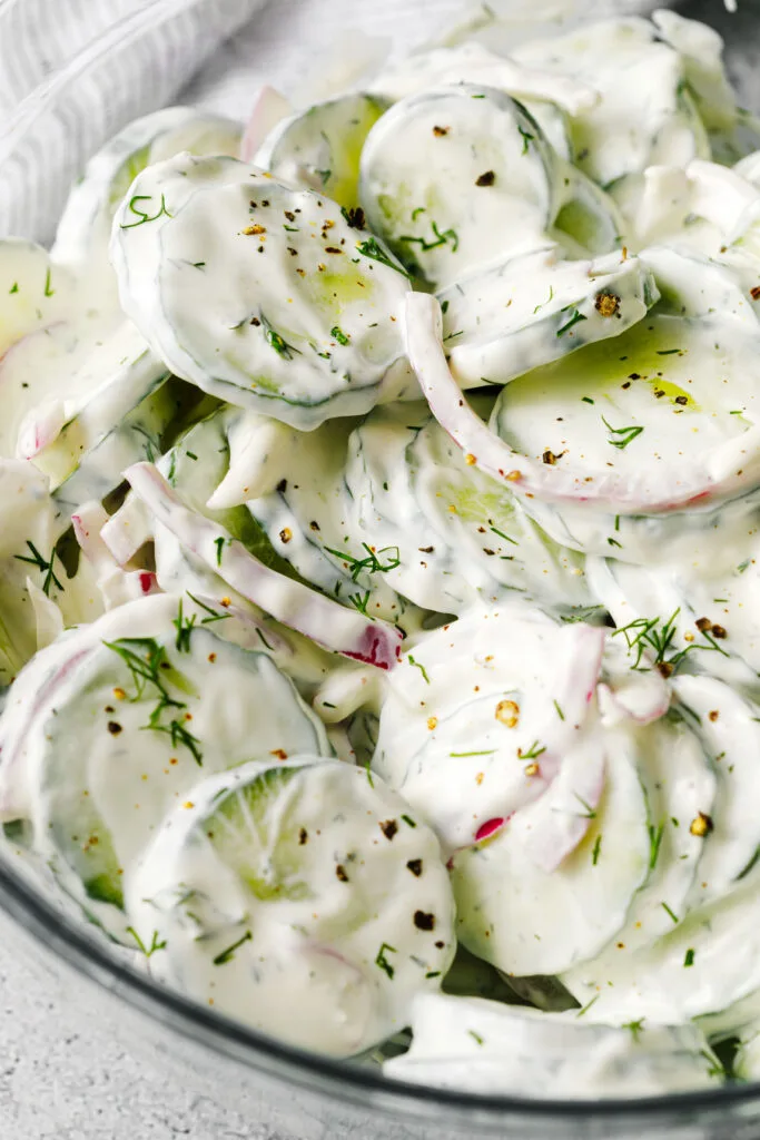 Salad garnished with fresh cracked pepper and fresh dill