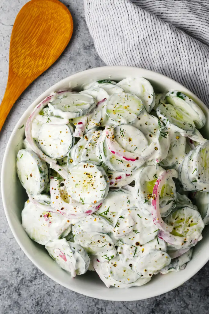 Creamy cucumber salad in a bowl on the counter