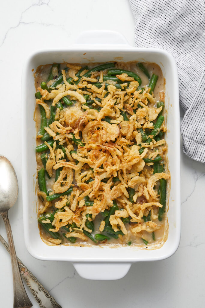 Green bean casserole in a glass dish with crispy fried onions on the top