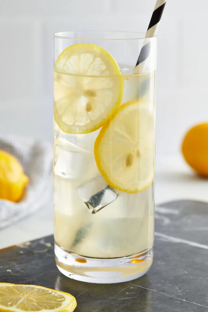glass of lemonade with lemon slices in the cup