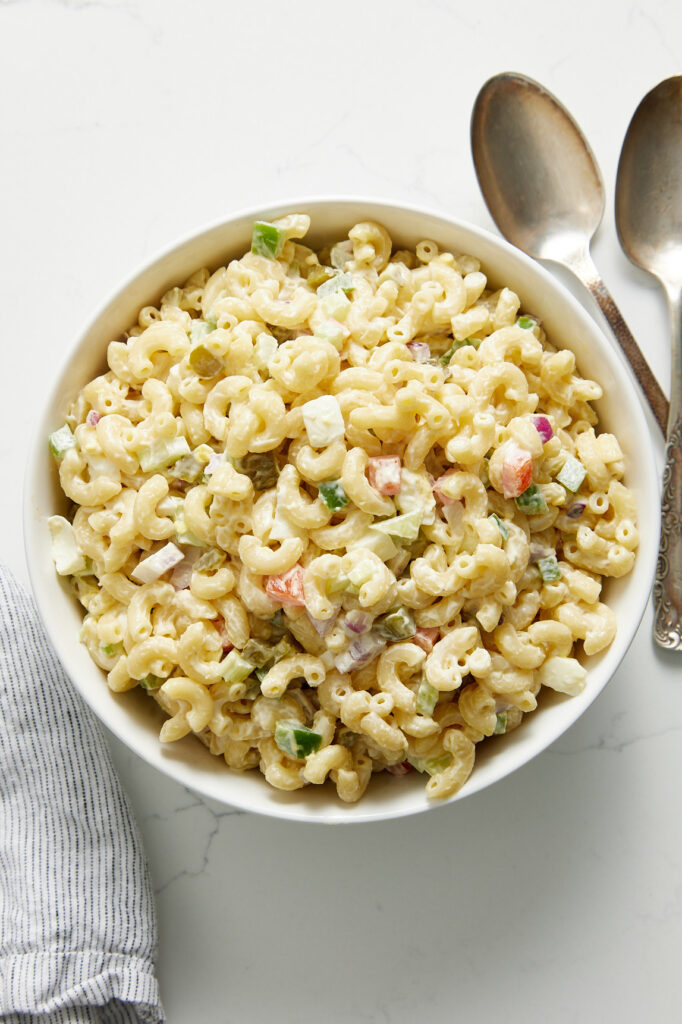 macaroni salad in a bowl with spoons
