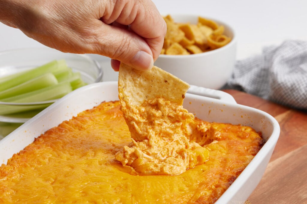 Cooked Buffalo chicken dip with a chip scooping out dip