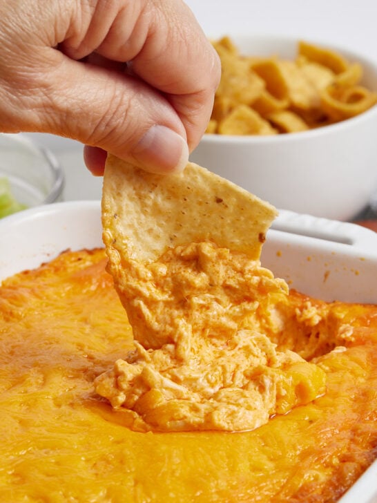 Cooked Buffalo chicken dip with a chip scooping out dip