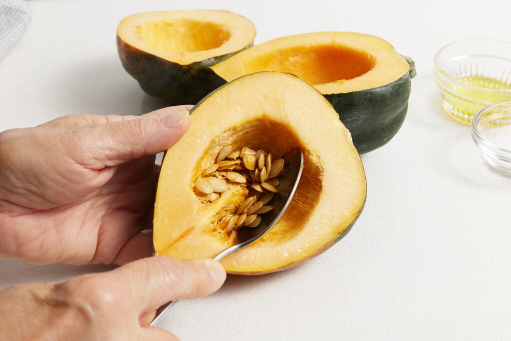 Using a spoon to remove seeds