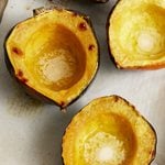 Roasted Acorn Squash halves on a sheet pan