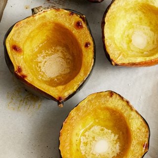 Roasted Acorn Squash halves on a sheet pan
