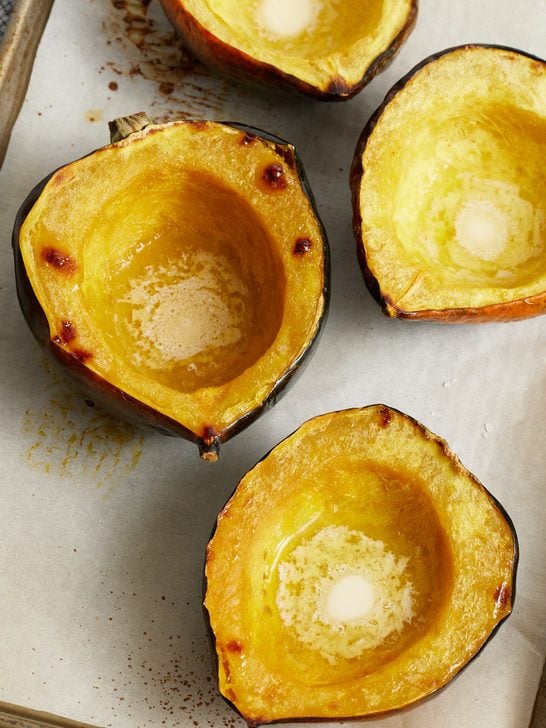 Roasted Acorn Squash halves on a sheet pan