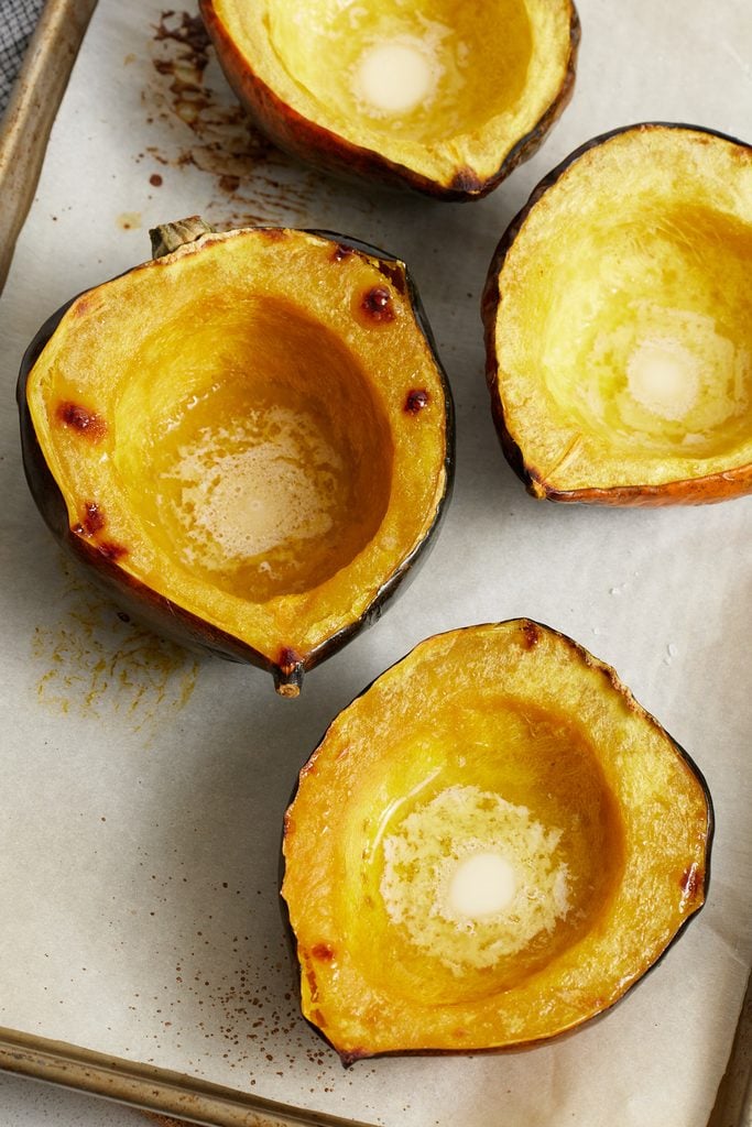 Roasted Acorn Squash halves on a sheet pan
