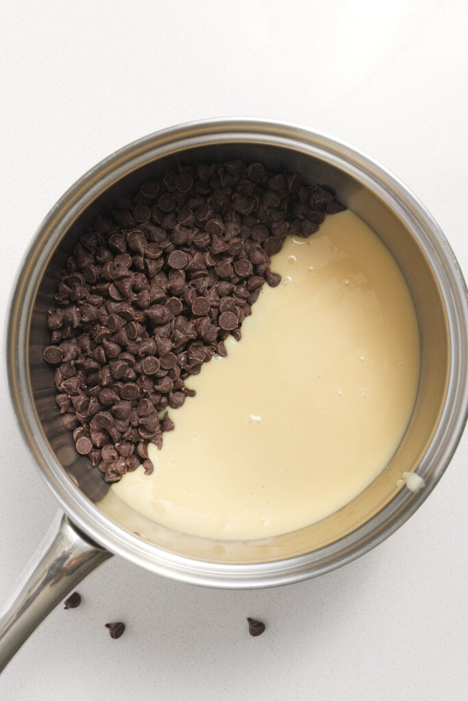 chocolate chips and sweetened condensed condensed milk in a pan