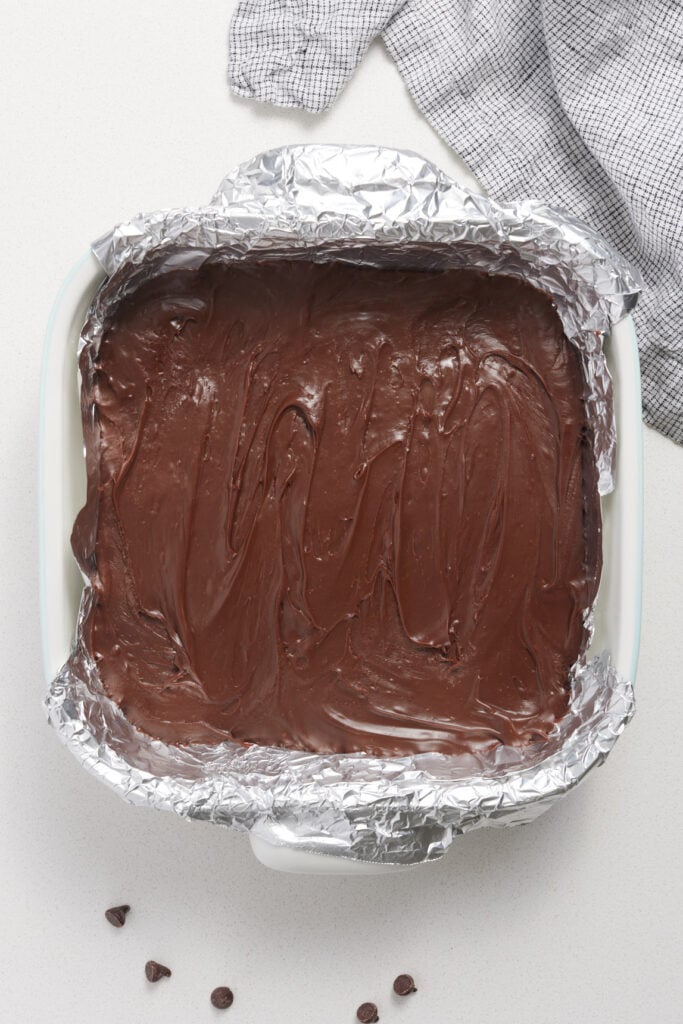 Warm fudge spread in a dish to cool