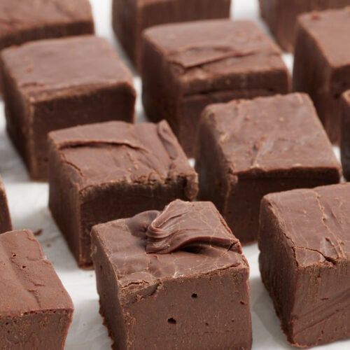 fudge cut into squares on parchment paper