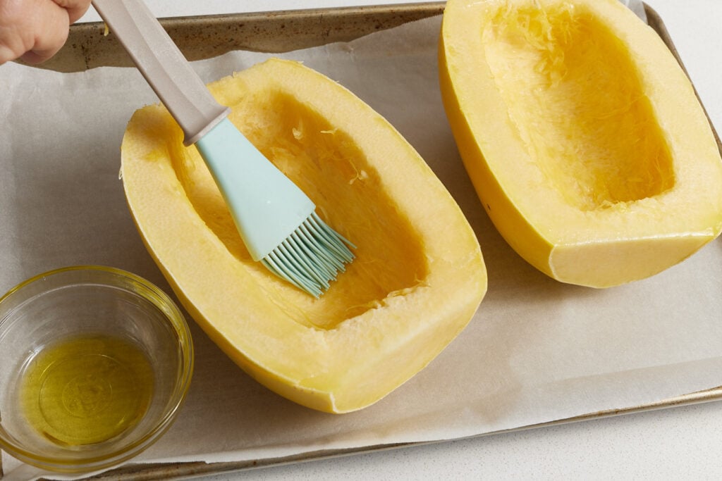 Brushing oil on side edges and inside squash